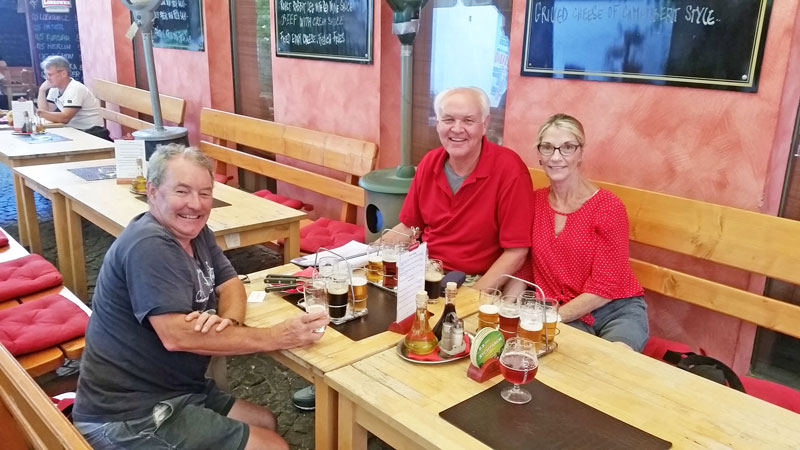 people sitting on a bench at a prague restaurant