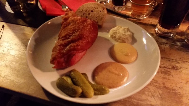 prague pork knuckle boneless on a plate with mustard and horseradish