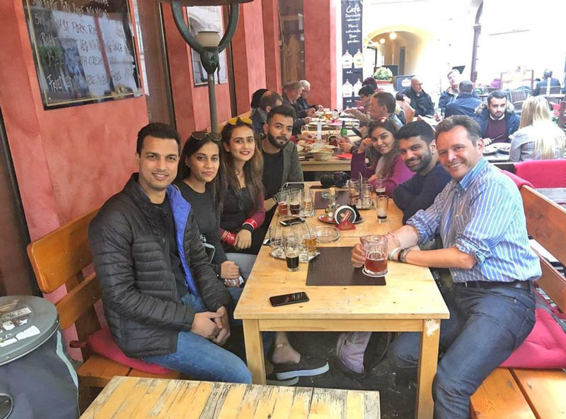 group drinking beer in a restaurant beer garden in prague