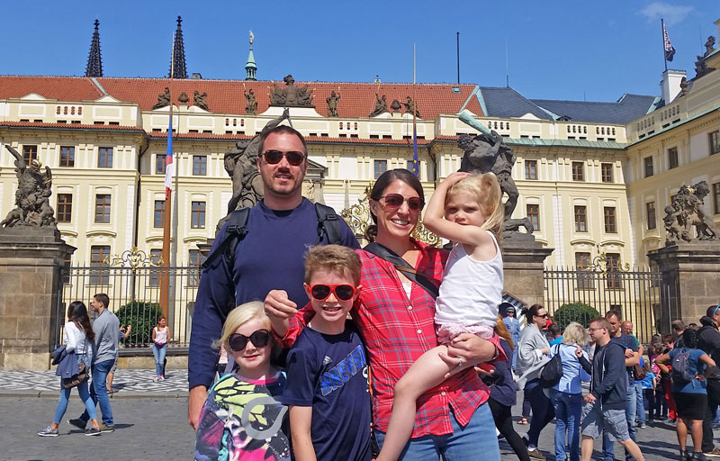 family in front of prague castle